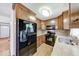 The kitchen boasts wooden cabinets, granite countertops, stainless steel appliances, and backsplash at 11 N Restin Rd, Greenwood, IN 46142