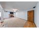 Spacious living room featuring a brick fireplace, neutral carpet, and ceiling fan at 11 N Restin Rd, Greenwood, IN 46142