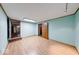 A cozy room with wood trim, light blue walls, and light wood-look flooring offers a versatile space at 11 N Restin Rd, Greenwood, IN 46142