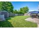 Spacious backyard with a patio, storage shed, lush lawn, and a privacy fence at 1112 Berwyn Rd, Whiteland, IN 46184