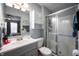 Well-lit bathroom with a white vanity, shower with sliding glass door, and coordinating fixtures at 1112 Berwyn Rd, Whiteland, IN 46184