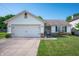 Charming one-story home with attached garage, well-manicured lawn and welcoming front porch at 1112 Berwyn Rd, Whiteland, IN 46184