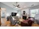Comfortable living room with fireplace, ceiling fan, and ample natural light at 1112 Berwyn Rd, Whiteland, IN 46184