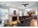 Open living area with fireplace, ceiling fan, and seamless flow to the kitchen at 1112 Berwyn Rd, Whiteland, IN 46184