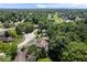 Aerial view of a neighborhood with tree coverage, and golf course in the background at 12674 Banbury Cir, Carmel, IN 46033