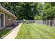 Well-maintained backyard features a patio area, a gray fence, and green grass at 12674 Banbury Cir, Carmel, IN 46033