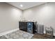 Wet bar in finished basement with granite countertop, mini fridge, modern cabinets, and designer decor at 12674 Banbury Cir, Carmel, IN 46033