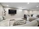 Relaxing finished basement featuring entertainment area with large screen TV, wet bar, and comfortable seating at 12674 Banbury Cir, Carmel, IN 46033