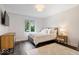 Bedroom featuring wood floors, a bed with white bedding, and bright window at 12674 Banbury Cir, Carmel, IN 46033