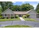 Charming ranch-style home with a brick facade, mature trees, and an attached two-car garage at 12674 Banbury Cir, Carmel, IN 46033