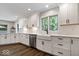 Modern kitchen featuring white cabinetry, stainless steel appliances, and dark hardwood floors at 12674 Banbury Cir, Carmel, IN 46033