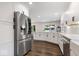 Bright kitchen with stainless steel refrigerator and views to the backyard through a large window at 12674 Banbury Cir, Carmel, IN 46033