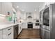 Well-lit kitchen features stainless steel appliances, white cabinets, and dark hardwood floors at 12674 Banbury Cir, Carmel, IN 46033