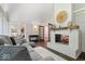 Cozy living room with white-washed brick fireplace, neutral tones, and modern furnishings at 12674 Banbury Cir, Carmel, IN 46033