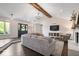 Spacious living room featuring a whitewashed brick fireplace, wood beam, and ample seating at 12674 Banbury Cir, Carmel, IN 46033