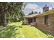 Expansive backyard featuring a well-maintained lawn and a brick patio with glass sliding doors at 13 Marywood Dr, Greenfield, IN 46140