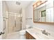Clean bathroom with a glass-enclosed shower, white tile flooring, and a vanity with a well-lit mirror at 13 Marywood Dr, Greenfield, IN 46140