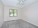 A cozy bedroom featuring plush gray carpeting and a window offering natural light at 13 Marywood Dr, Greenfield, IN 46140