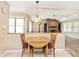 Open dining area with a wooden table and view of the living room fireplace, enhancing the home's appeal at 13 Marywood Dr, Greenfield, IN 46140