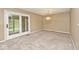 Bright dining room with carpeted floors and sliding glass doors leading to the outdoor space at 13 Marywood Dr, Greenfield, IN 46140