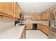 Spacious kitchen with wood cabinets and stainless steel refrigerator, perfect for cooking and entertaining at 13 Marywood Dr, Greenfield, IN 46140
