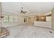 Open floor plan with living room flowing into kitchen, featuring neutral tones and modern lighting at 13 Marywood Dr, Greenfield, IN 46140
