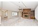 Inviting living space with a brick fireplace, built-in shelves, and a view of the entry area at 13 Marywood Dr, Greenfield, IN 46140