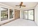Enclosed patio features brick accents, sliding glass doors, and vertical blinds for privacy at 13 Marywood Dr, Greenfield, IN 46140