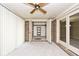 Enclosed patio reveals a storage area with shelving through double doors, offering practical storage solutions at 13 Marywood Dr, Greenfield, IN 46140