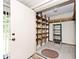 Storage room has built-in wooden shelving and is accessible through a door, offering great organizational potential at 13 Marywood Dr, Greenfield, IN 46140