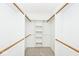 Spacious walk-in closet with shelving and wooden rods, providing ample storage space at 13 Marywood Dr, Greenfield, IN 46140