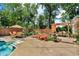 Lush backyard space offers an inviting in-ground pool, multiple seating areas, and tranquil landscaping at 1340 Eustis Dr, Indianapolis, IN 46229