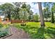 Expansive backyard featuring mature trees, gardens, and storage sheds, perfect for outdoor activities at 1340 Eustis Dr, Indianapolis, IN 46229