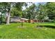 Lush backyard with mature trees, landscaping, and plenty of green space offers serenity and privacy at 1340 Eustis Dr, Indianapolis, IN 46229