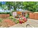 Charming backyard featuring a cozy patio area with pergola, lush landscaping, and outdoor seating at 1340 Eustis Dr, Indianapolis, IN 46229