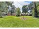 Spacious backyard with lush green grass and mature trees offering ample space for recreation and relaxation at 1340 Eustis Dr, Indianapolis, IN 46229