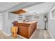Finished basement wet bar with wooden countertop, shelving, and decorative clock for entertaining at 1340 Eustis Dr, Indianapolis, IN 46229
