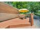 Outdoor deck with a table, chairs, and umbrella for relaxing and enjoying the outdoors at 1340 Eustis Dr, Indianapolis, IN 46229