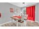 Bright dining room with white chairs, wood table, and red accents near a sliding glass door at 1340 Eustis Dr, Indianapolis, IN 46229