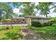 Beautiful single-story home with brick and stone exterior, large deck, and well-maintained landscaping at 1340 Eustis Dr, Indianapolis, IN 46229