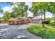 Back exterior of home featuring large deck, well-maintained lawn and mature trees at 1340 Eustis Dr, Indianapolis, IN 46229