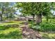 Charming front yard featuring a stone walkway and lush landscaping leading to the home at 1340 Eustis Dr, Indianapolis, IN 46229