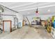 Spacious garage featuring ample storage, workbench area, and a convenient access door at 1340 Eustis Dr, Indianapolis, IN 46229