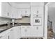 Well-lit kitchen features white cabinets, updated appliances, and a stylish backsplash at 1340 Eustis Dr, Indianapolis, IN 46229