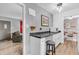 Open kitchen layout with white cabinets, a microwave, and a breakfast bar with seating at 1340 Eustis Dr, Indianapolis, IN 46229
