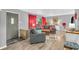 Comfortable living room with hardwood floors, a grey sofa, and bright red curtains at 1340 Eustis Dr, Indianapolis, IN 46229