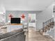 Bright living room with hardwood floors, red star decor, and open view to the kitchen at 1340 Eustis Dr, Indianapolis, IN 46229