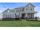 Charming two-story home featuring gray siding, black brick accents, and a well-manicured lawn at 1439 Chatham Hills Blvd, Westfield, IN 46074