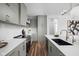 Stylish sage green kitchen featuring stainless steel appliances, an island with breakfast bar, and sleek countertops at 1461 Whistle Way, Westfield, IN 46074