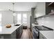 Bright kitchen features stainless steel appliances, sage green cabinets, and an island with seating at 1461 Whistle Way, Westfield, IN 46074